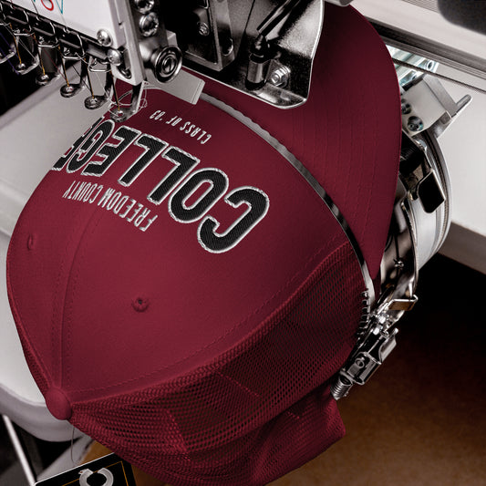 Maroon trucker cap with "Freedom County College" embroidered on the front.