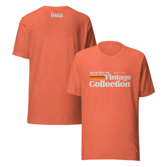 Orange unisex t-shirt with "Never Give Up Vintage Collection Since 1983" graphic.