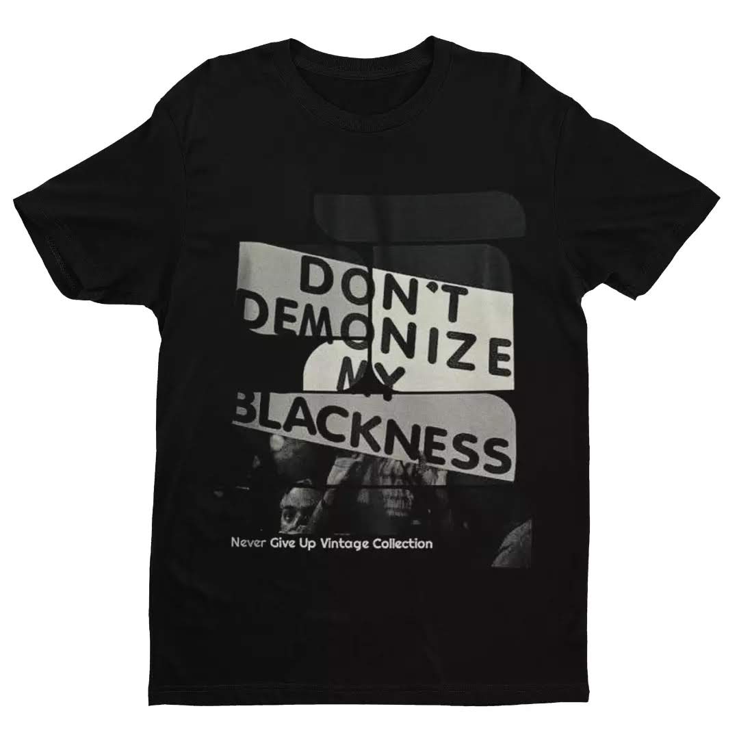 Black t-shirt with "Don't Demonize My Blackness" graphic.