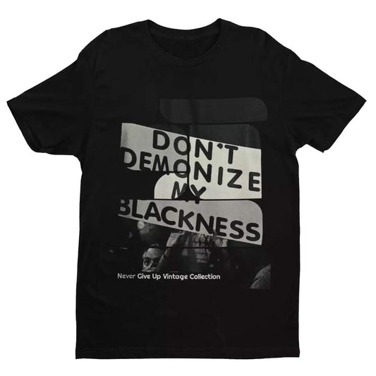 Black t-shirt with "Don't Demonize My Blackness" graphic.