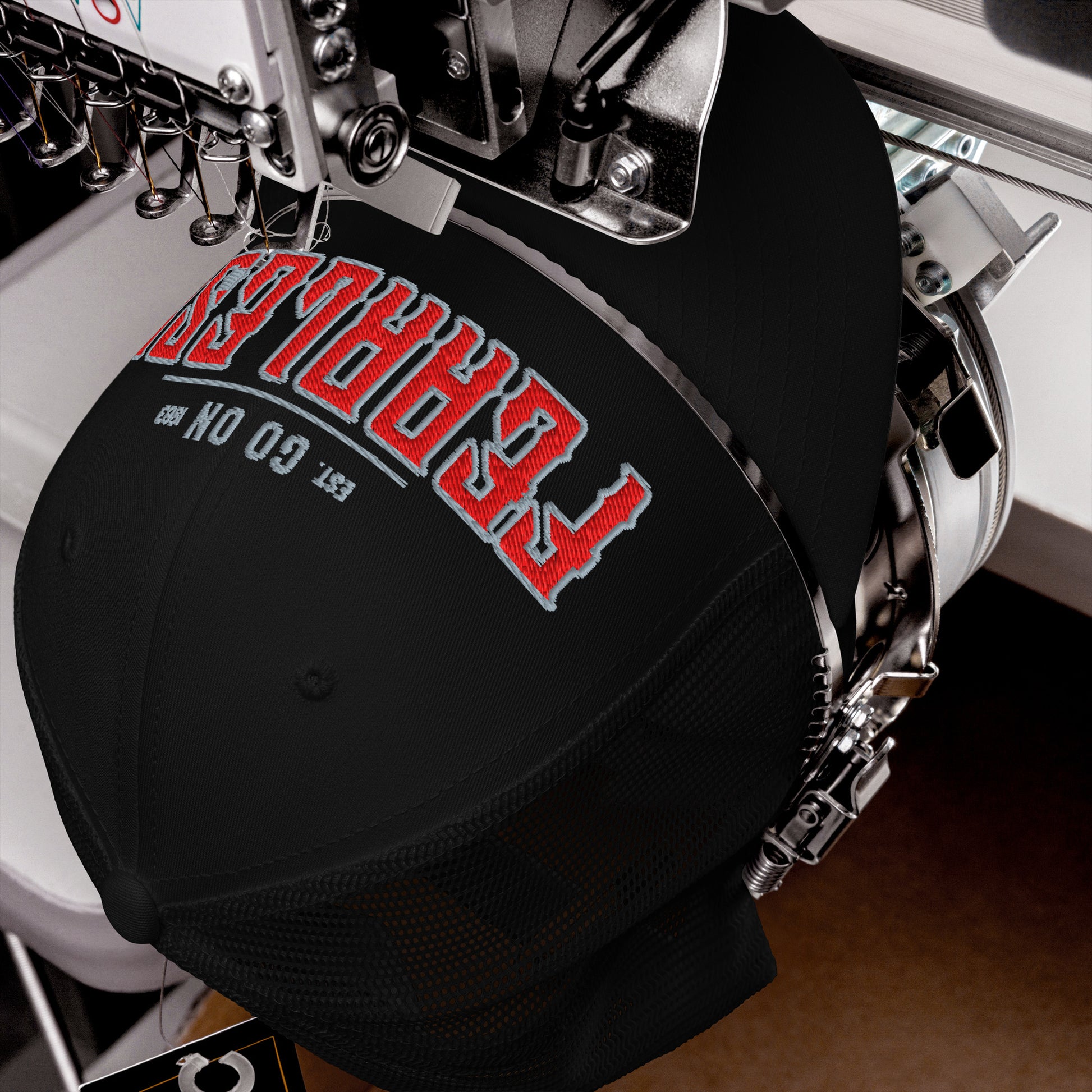 Black trucker cap with red and gray embroidered text.