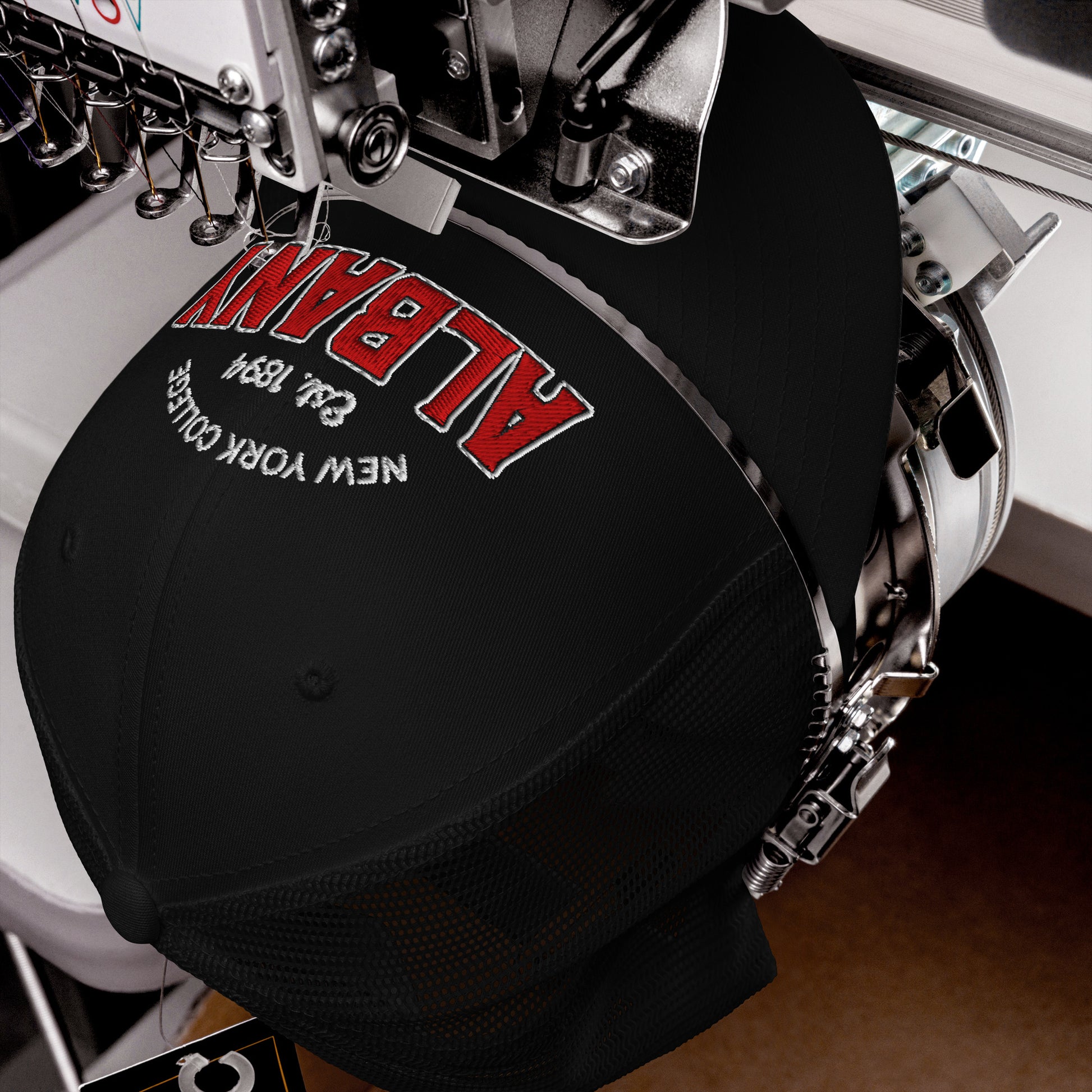 Albany College unisex trucker cap with embroidered text.