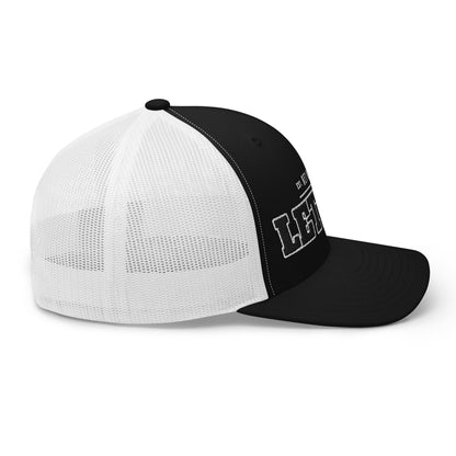 Black and white trucker cap with white mesh back and embroidered text.