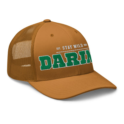Brown trucker cap with green "DARIEN" embroidery and "EST. STAY WILD 1983" text.