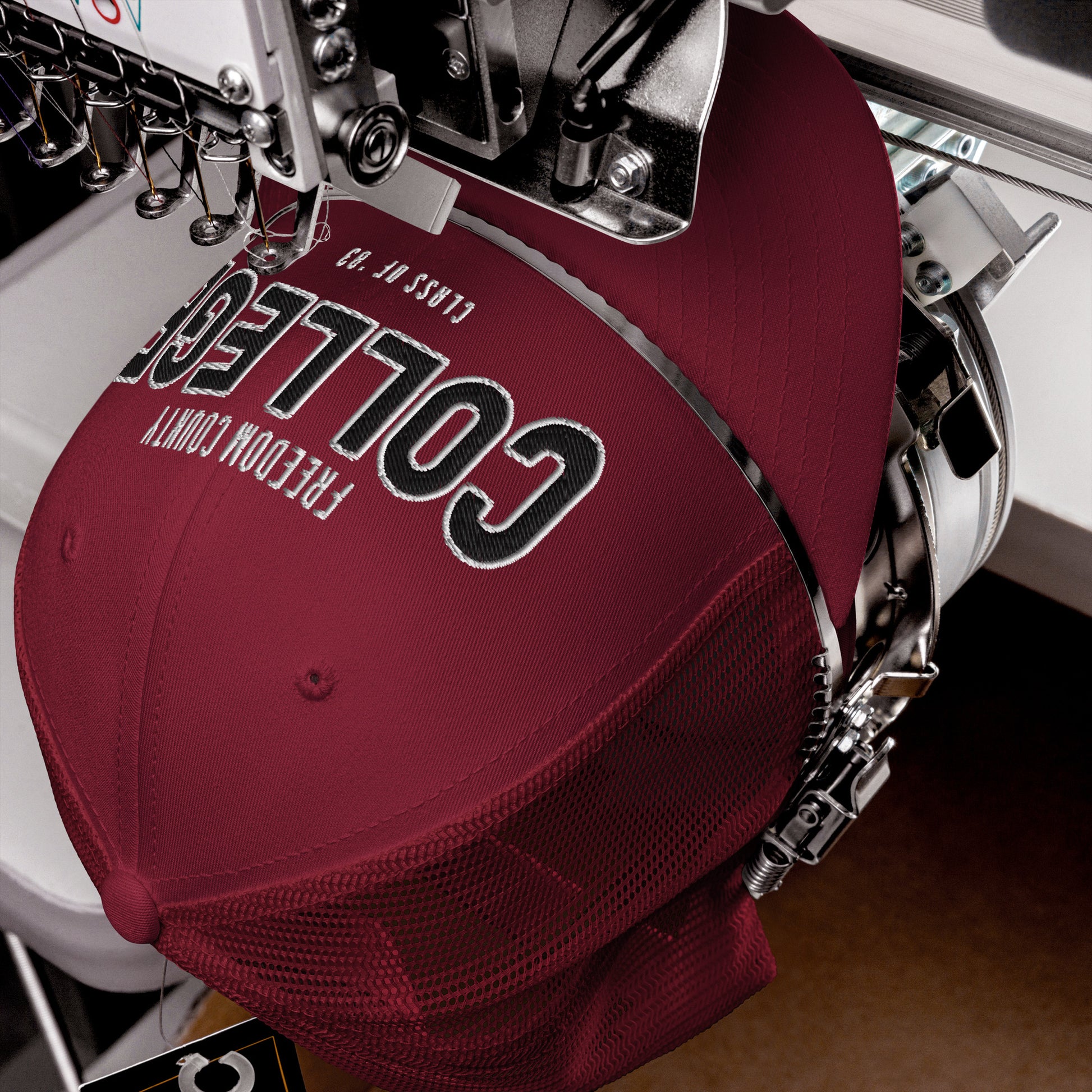 Maroon trucker cap with "Freedom County College" embroidered on the front.