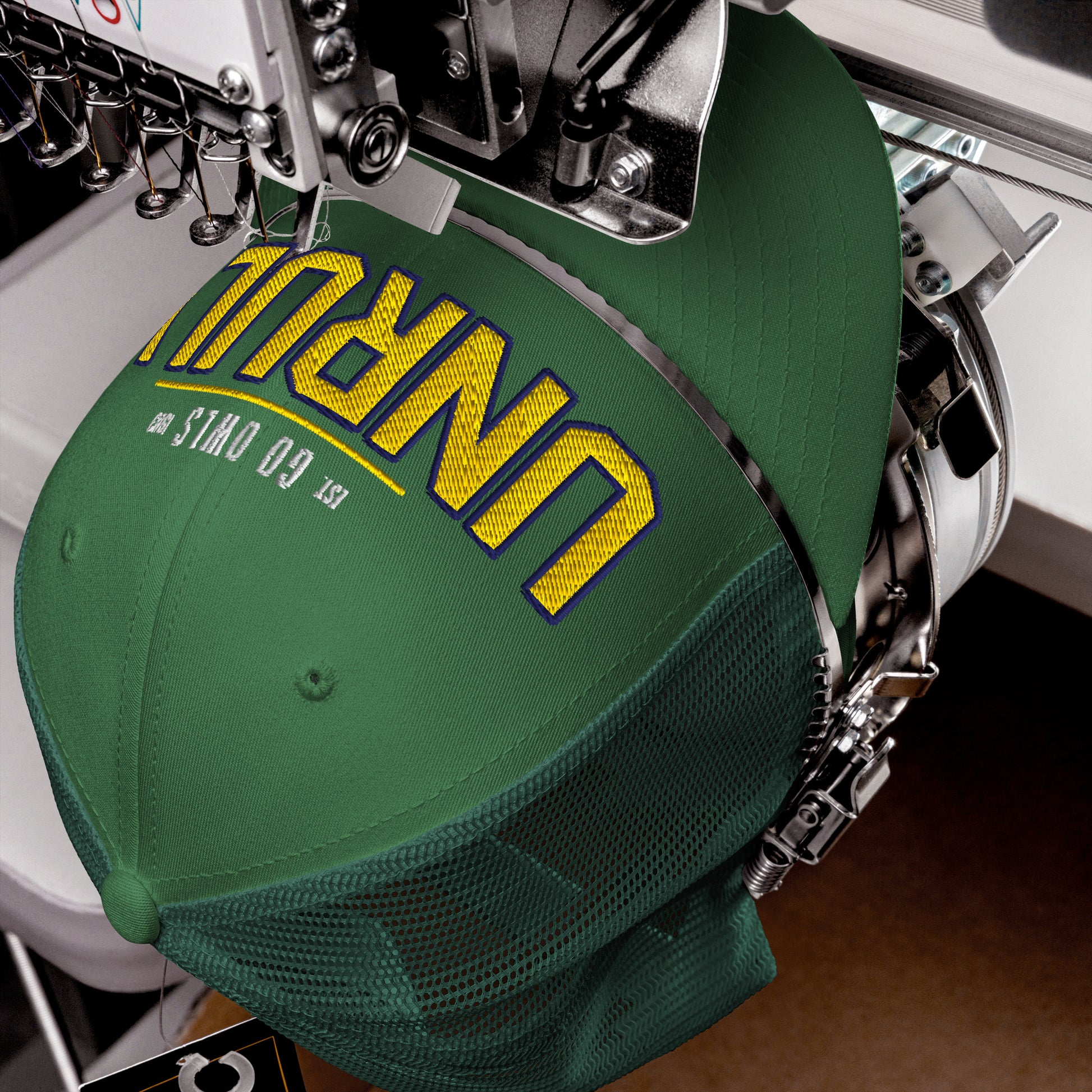 Green trucker cap with yellow and blue embroidered text.