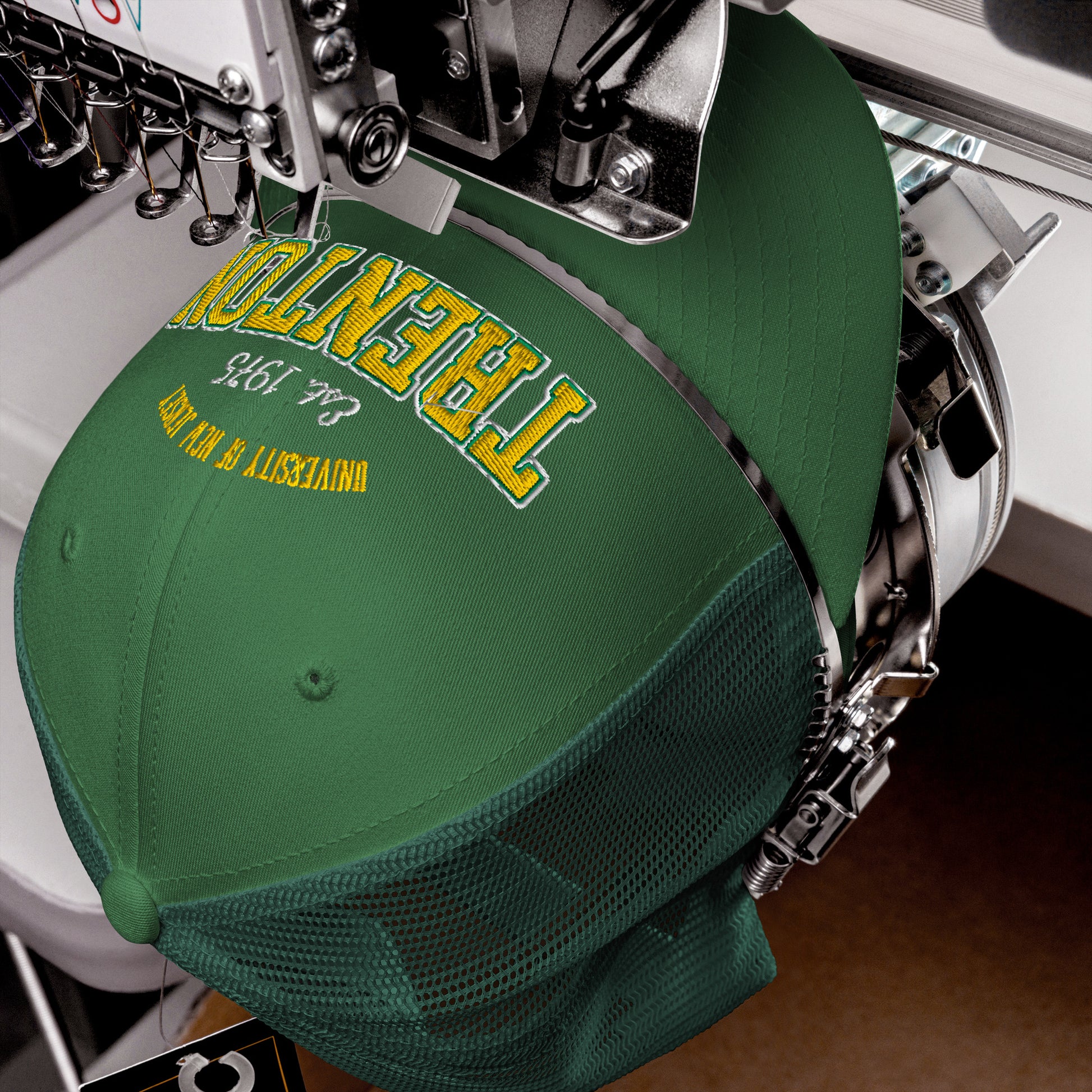 Green Trenton trucker cap with yellow embroidery and mesh back.