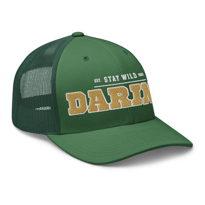 Green trucker cap with "DARI" and "EST. STAY WILD 1983" embroidered on the front.
