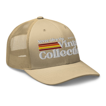 Retro Collection trucker cap in tan with embroidered text and stripes.