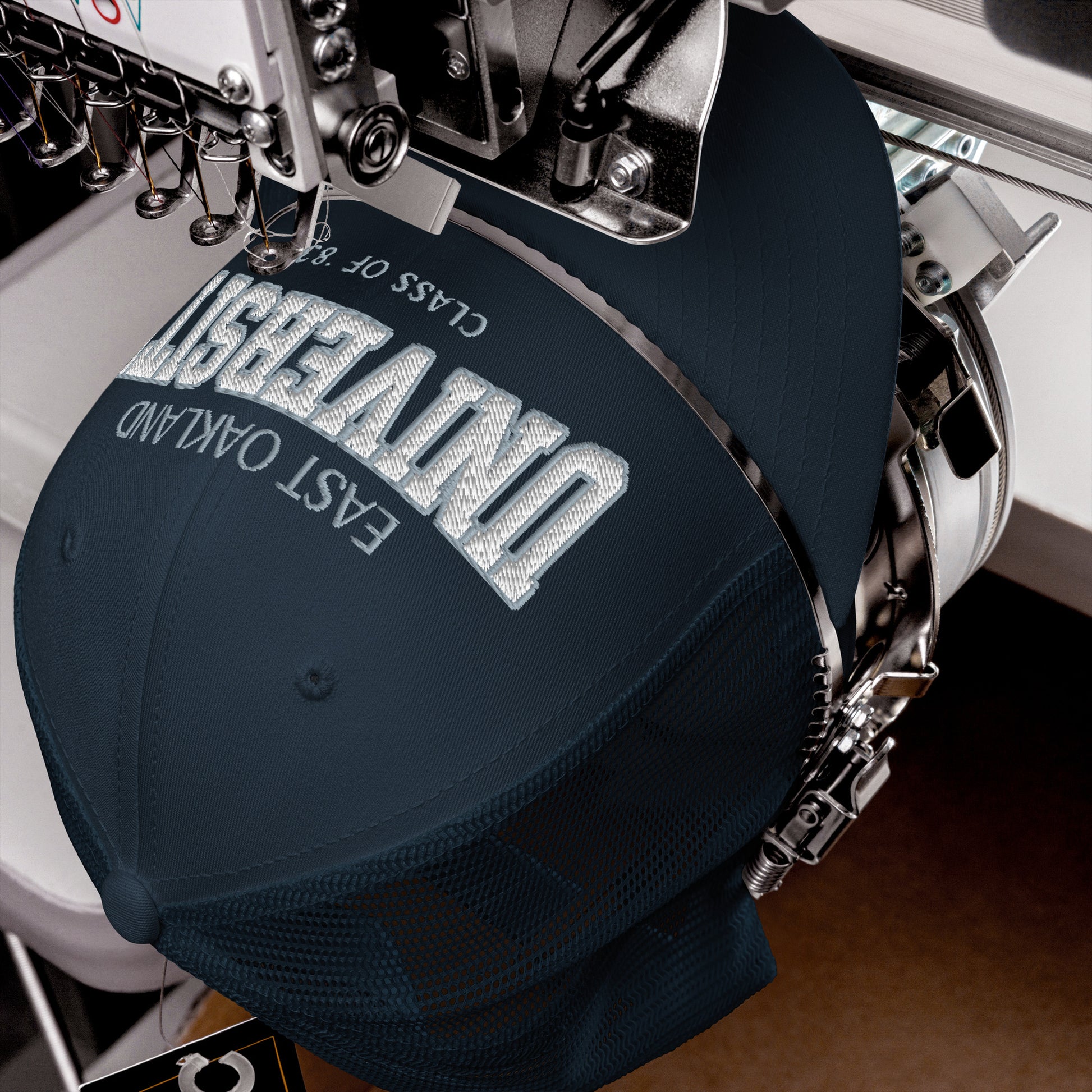East Oakland University trucker cap with embroidered text.