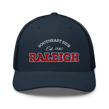 Navy blue trucker cap with "Raleigh" and "Southeast Side Est. 1860" embroidered on the front.
