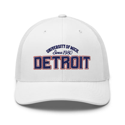 White trucker cap with "University of Mich. Since 1980 Detroit" embroidered on the front.