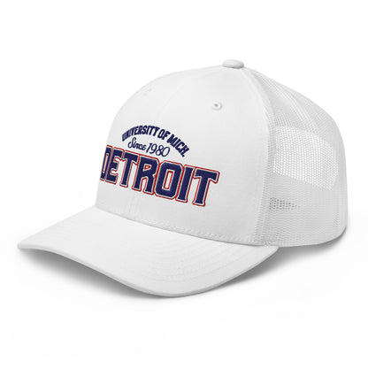 White trucker cap with "University of Mich Detroit Since 1980" embroidery.
