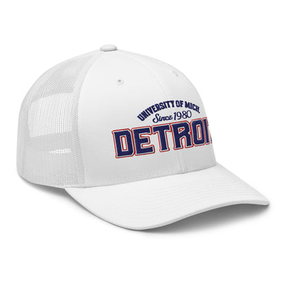 White trucker cap with "Detroit" and "University of Mich Since 1980" embroidery.