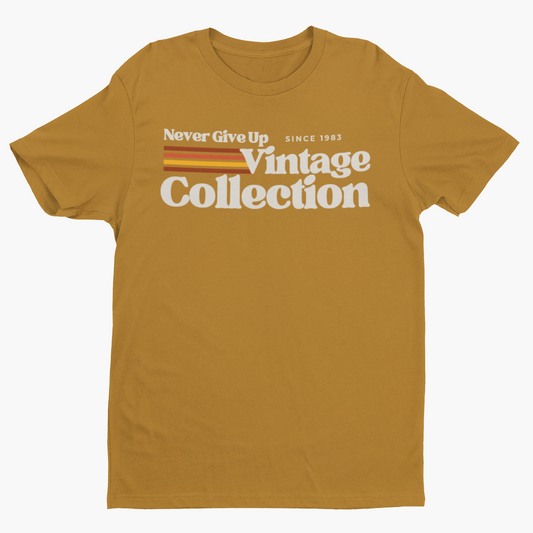 A mustard yellow t-shirt with "Never Give Up Vintage Collection Since 1983" text.